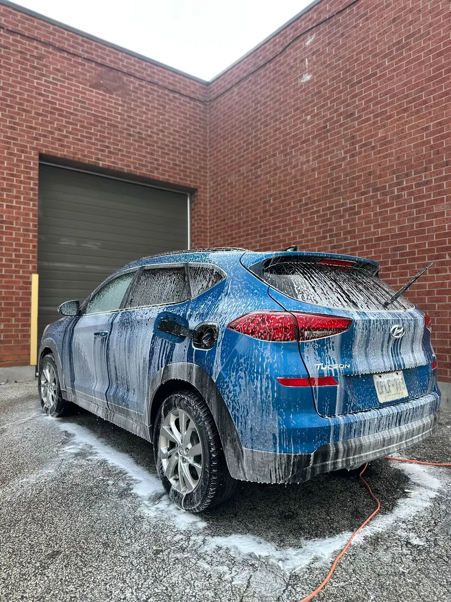Blue SUV receiving a foam wash